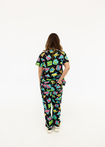 woman in black and bright colour retro Dino scrub set