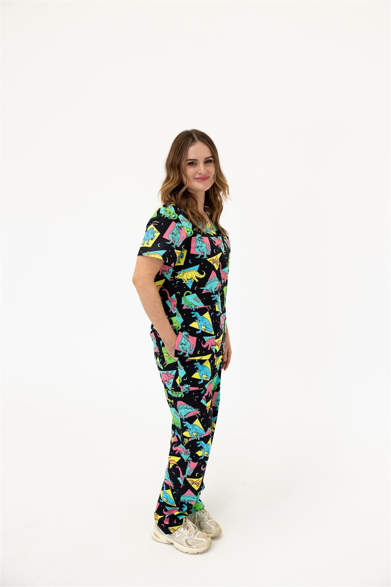 woman in black and bright colour retro Dino scrub set