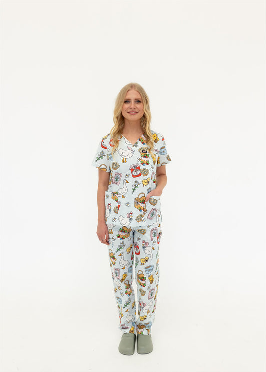 woman wearing cottage core themed scrub set in blue 