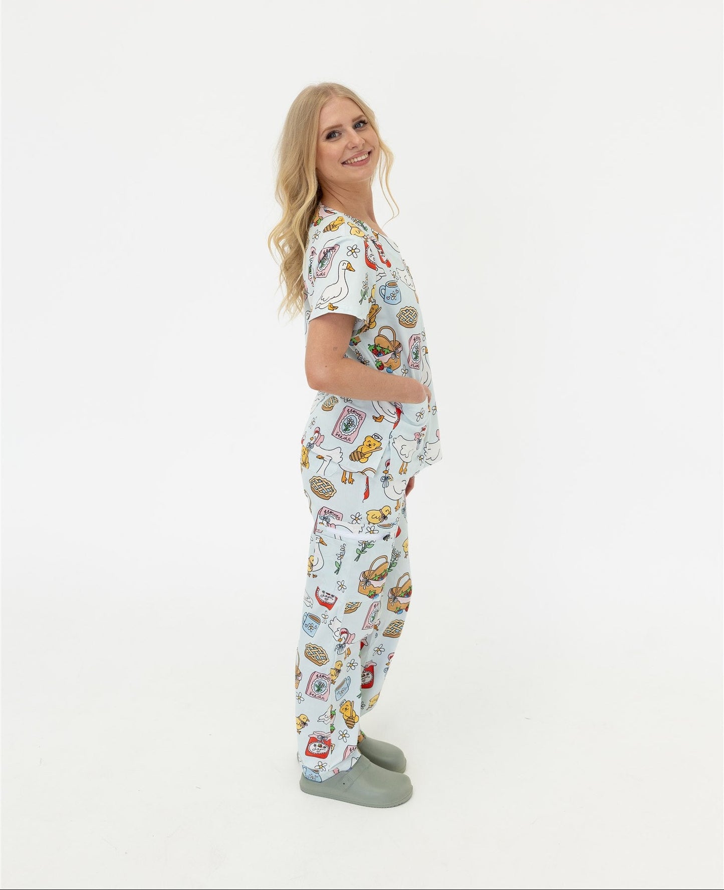 woman wearing cottage core themed scrub set in blue 