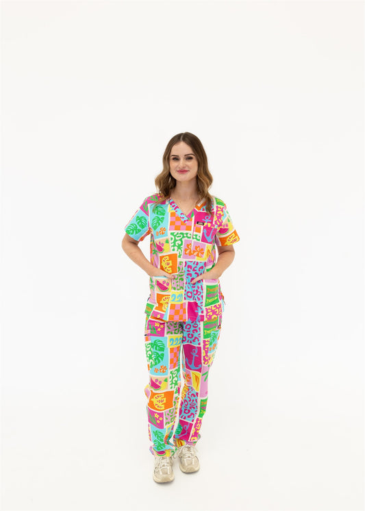 woman wearing a bright fun summery scrub set