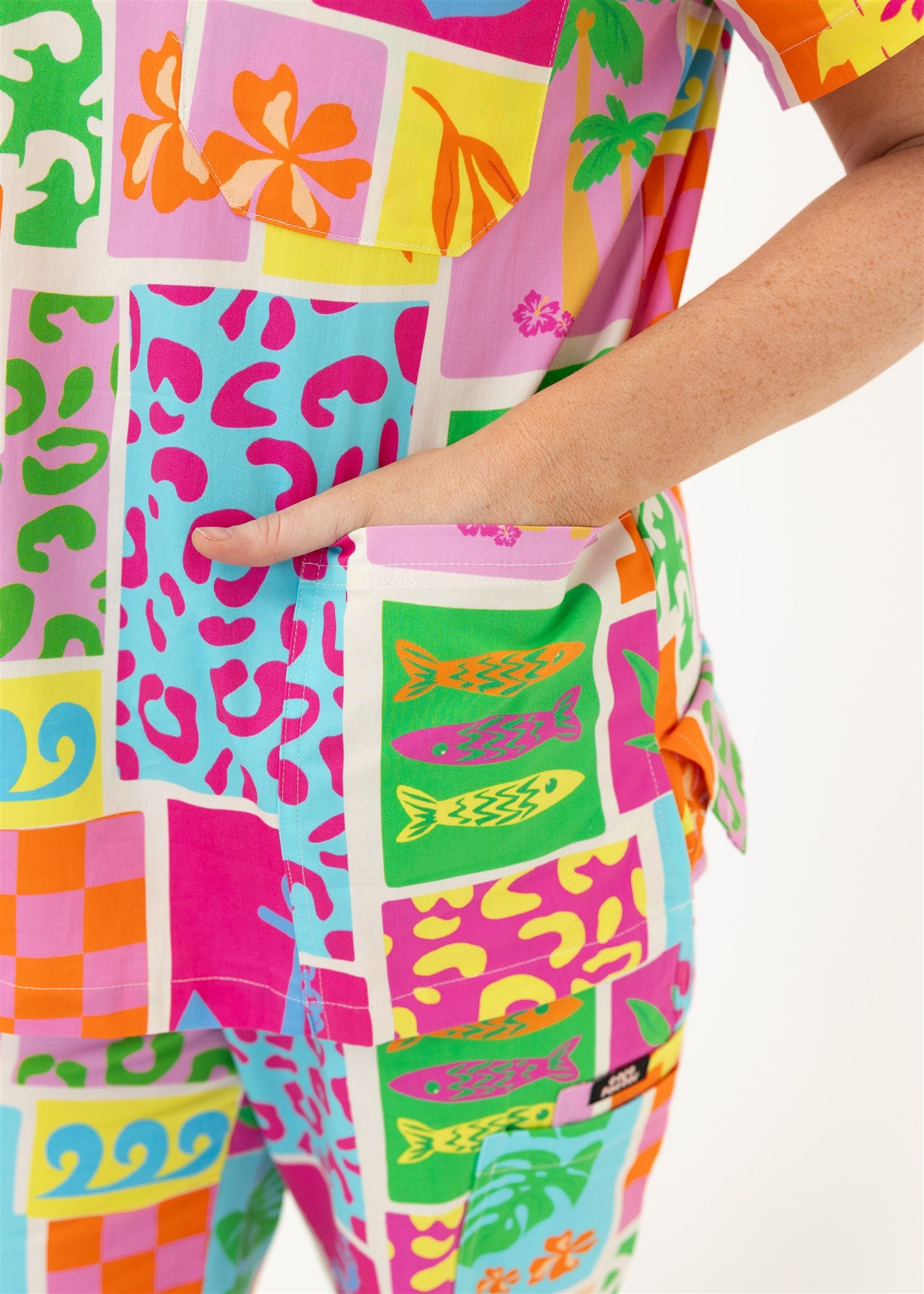 woman wearing a bright fun summery scrub set top