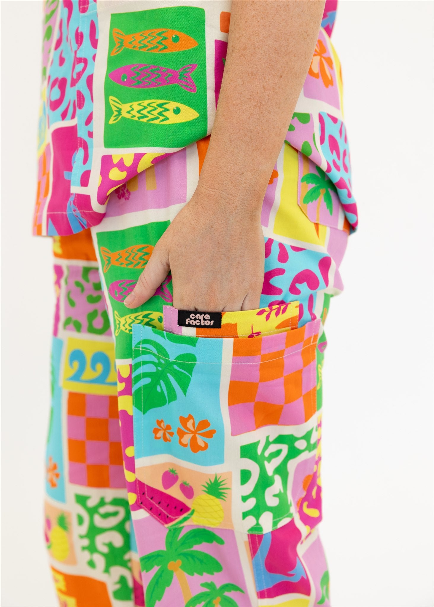 woman wearing a bright fun summery scrub set pants