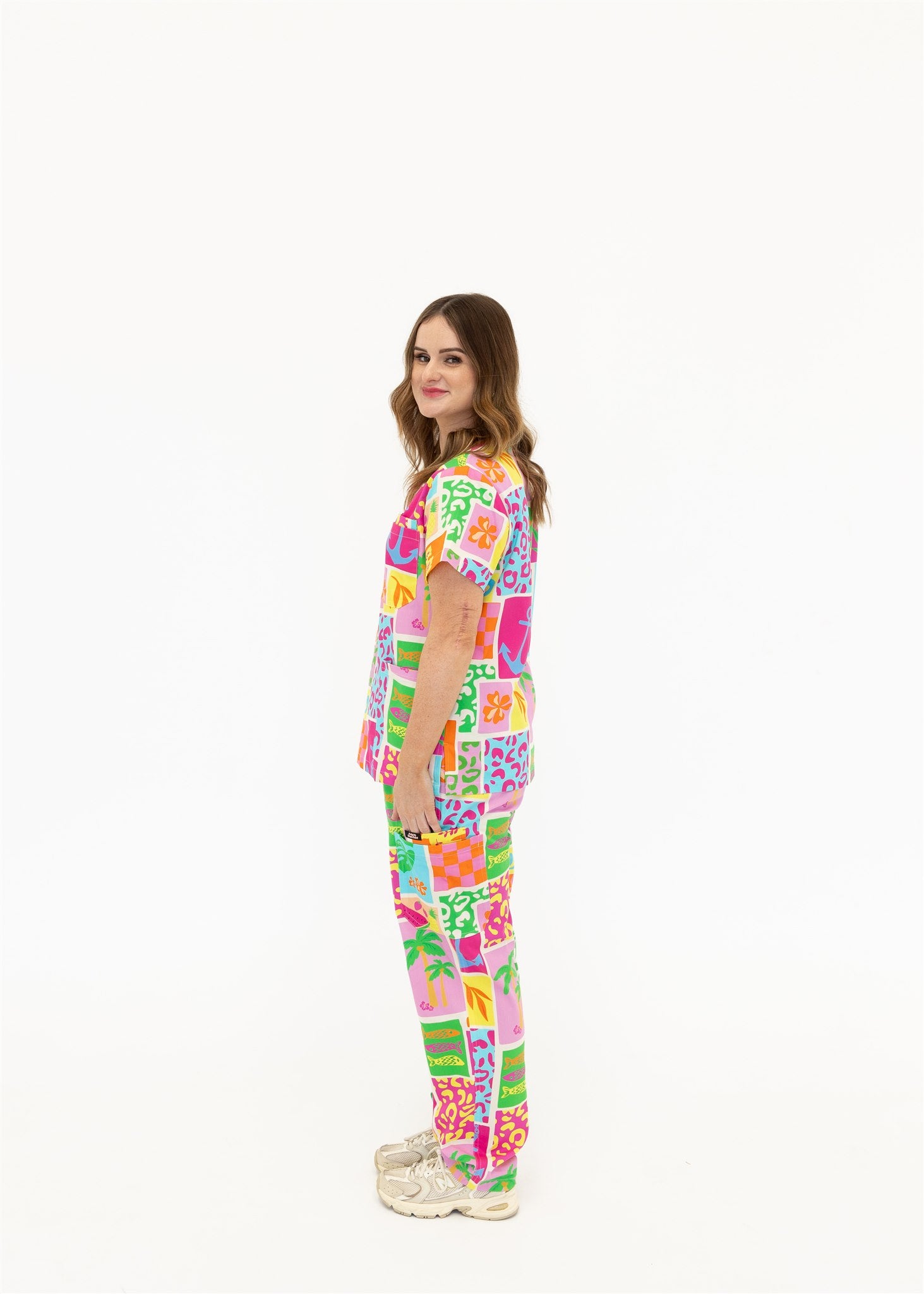 woman wearing a bright fun summery scrub set