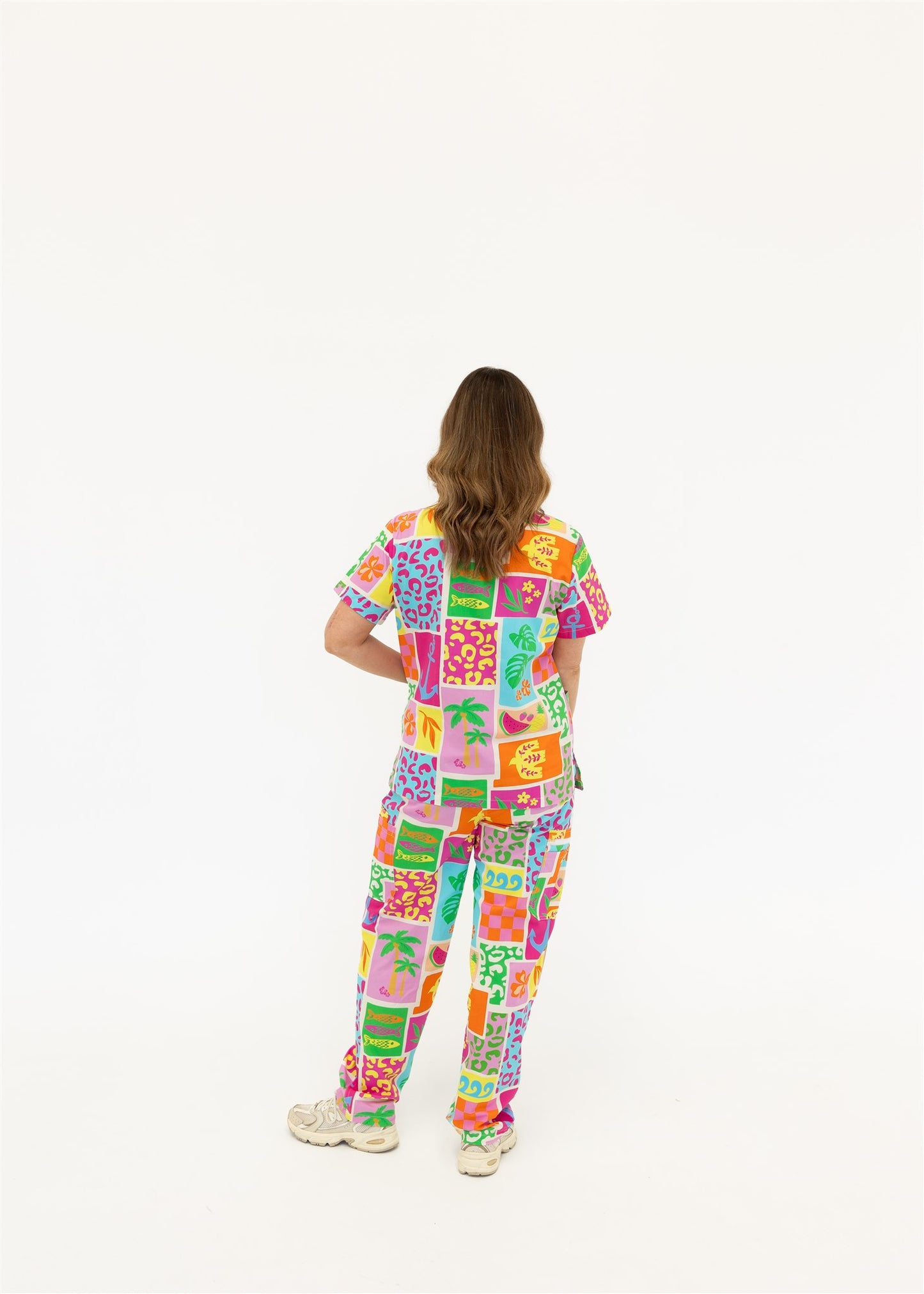 woman wearing a bright fun summery scrub set