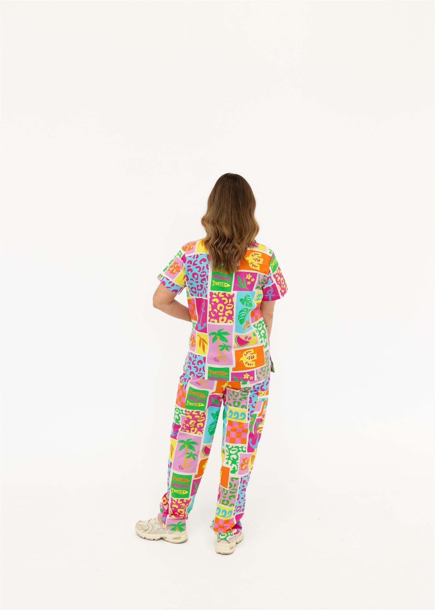 woman wearing a bright fun summery scrub set