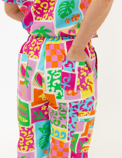 woman wearing a bright fun summery scrub set pants
