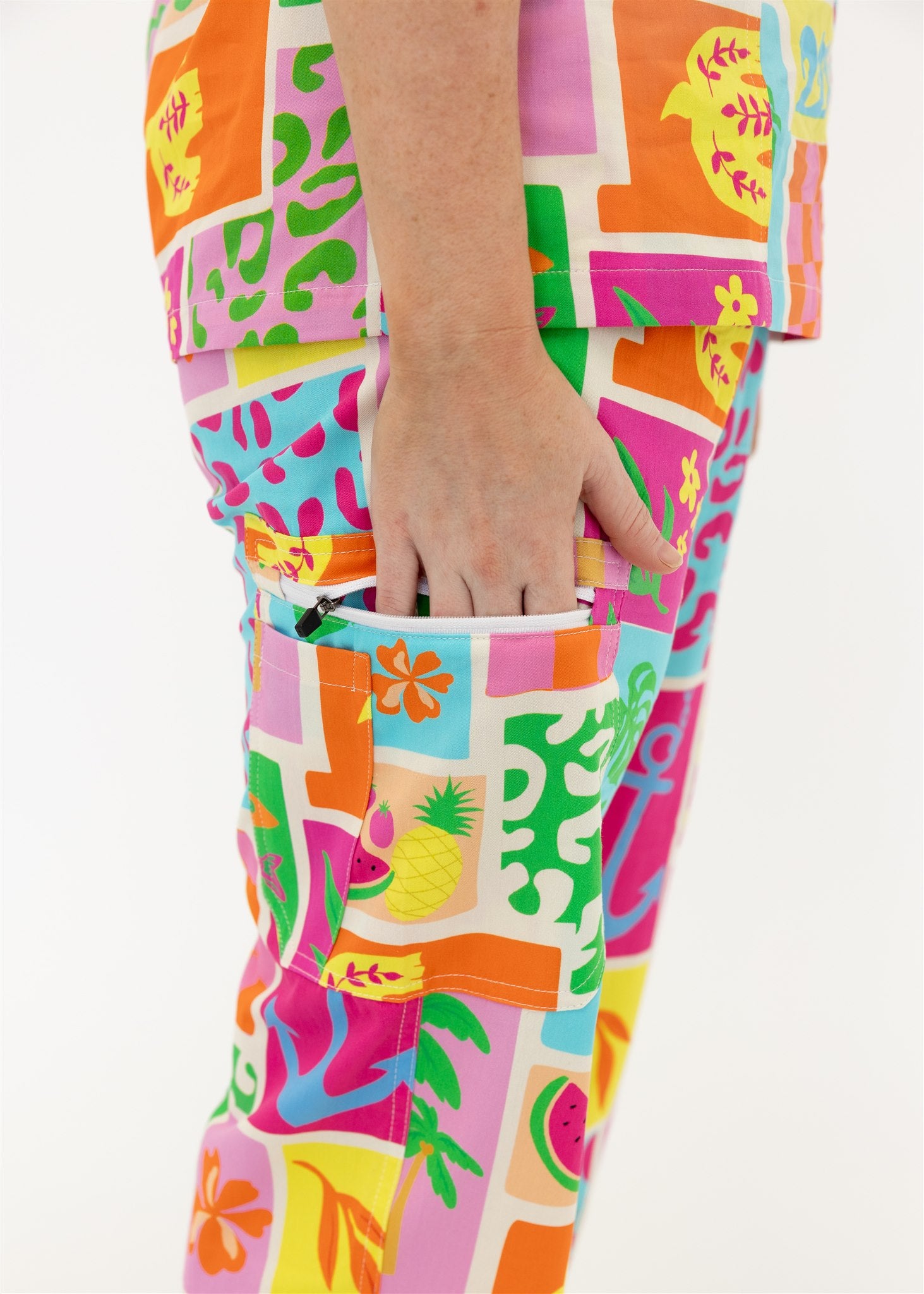 woman wearing a bright fun summery scrub set pants