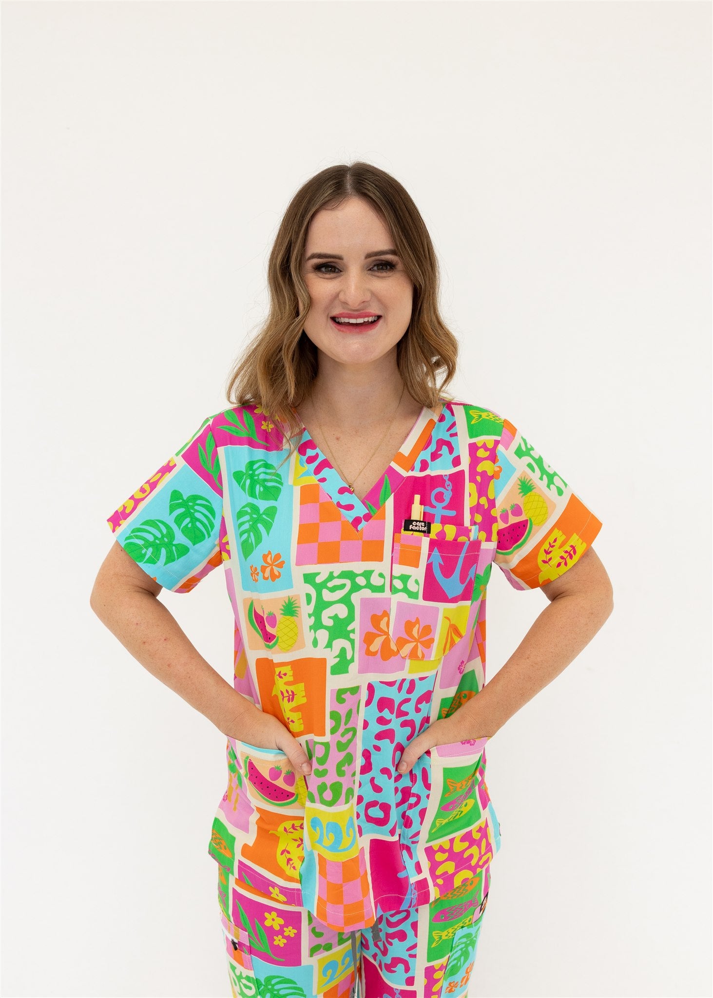woman wearing a bright fun summery scrub set
