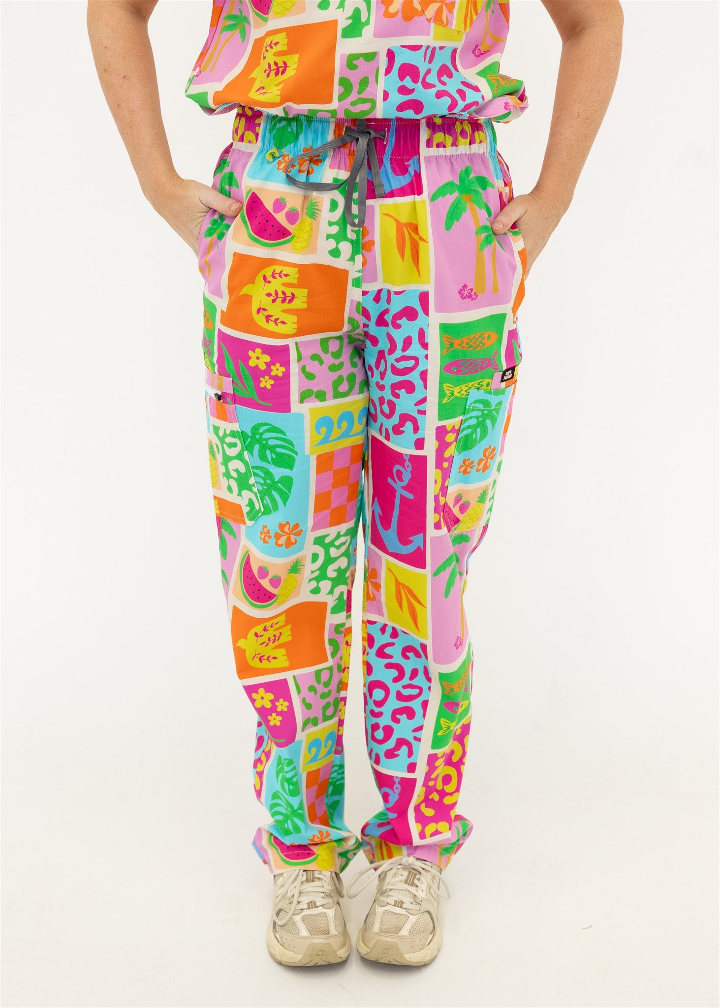woman wearing a bright fun summery scrub set pants
