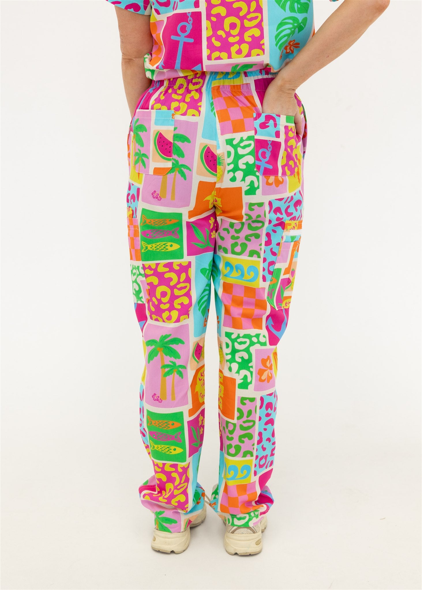 woman wearing a bright fun summery scrub set pants