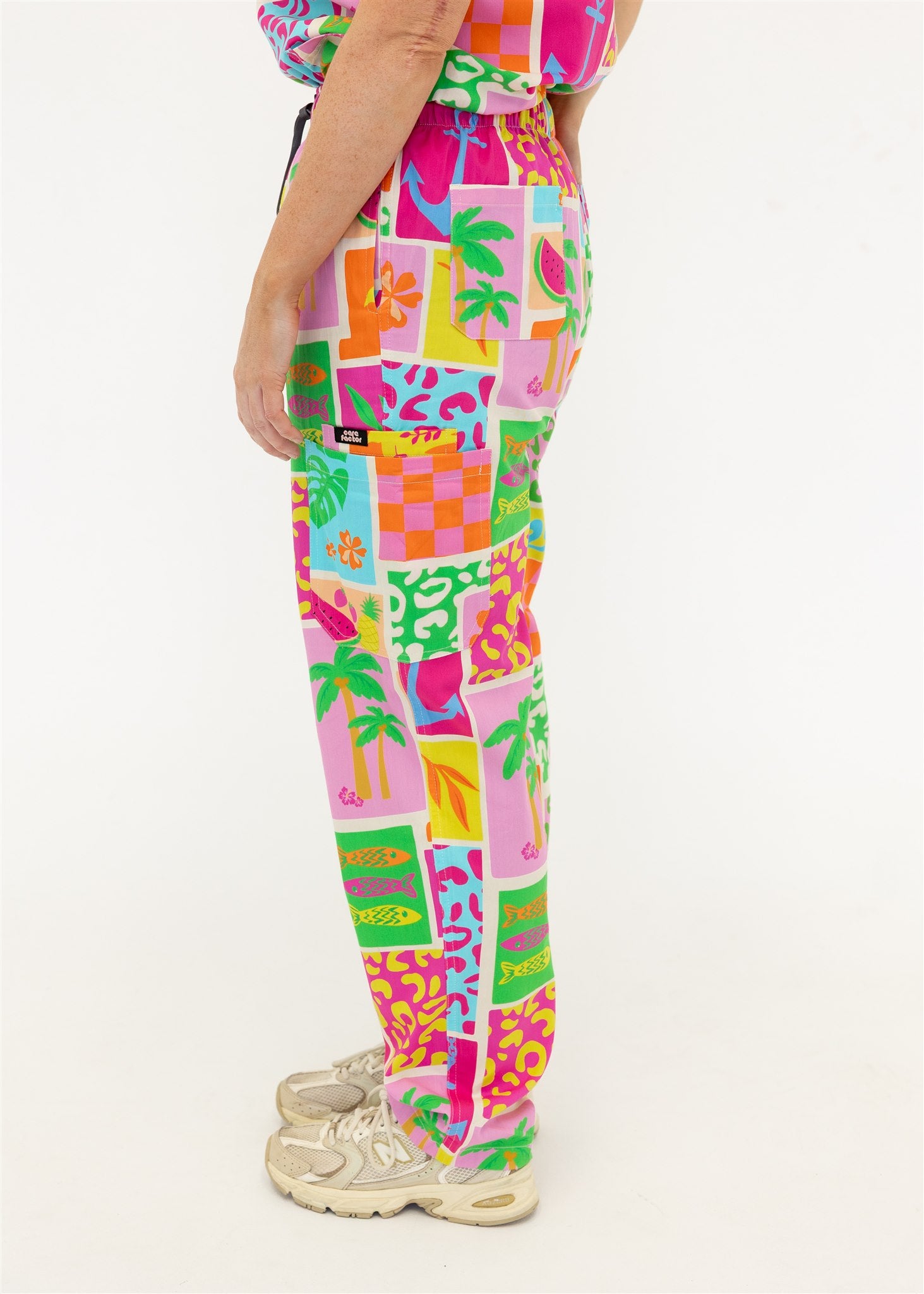 woman wearing a bright fun summery scrub set pants