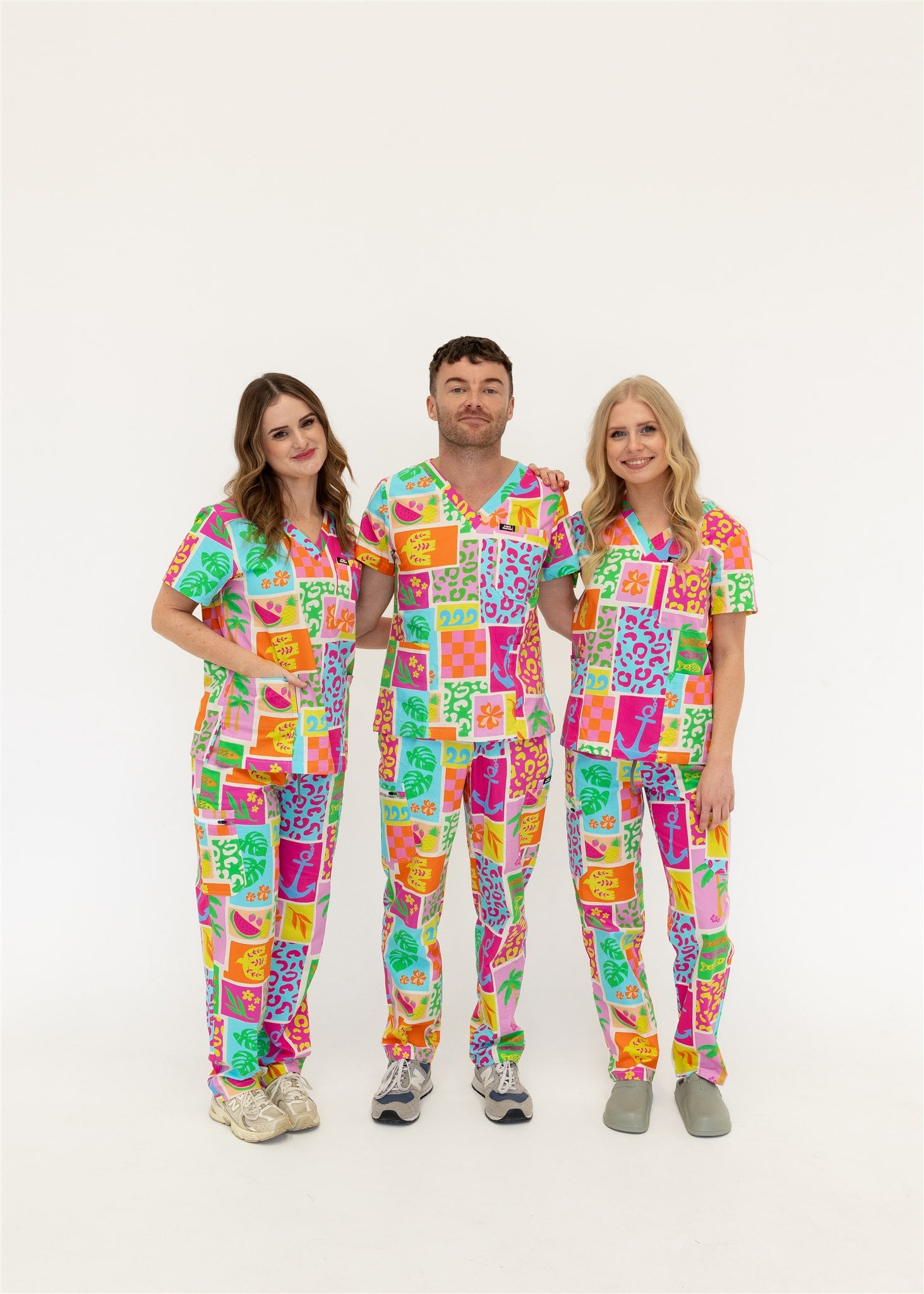 group of nurses wearing bright fun summery scrub sets