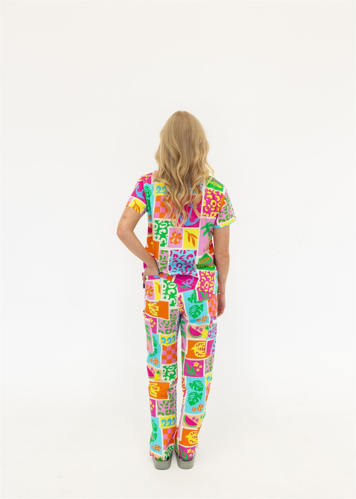 woman wearing a bright fun summery scrub set