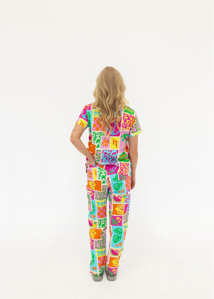 woman wearing a bright fun summery scrub set