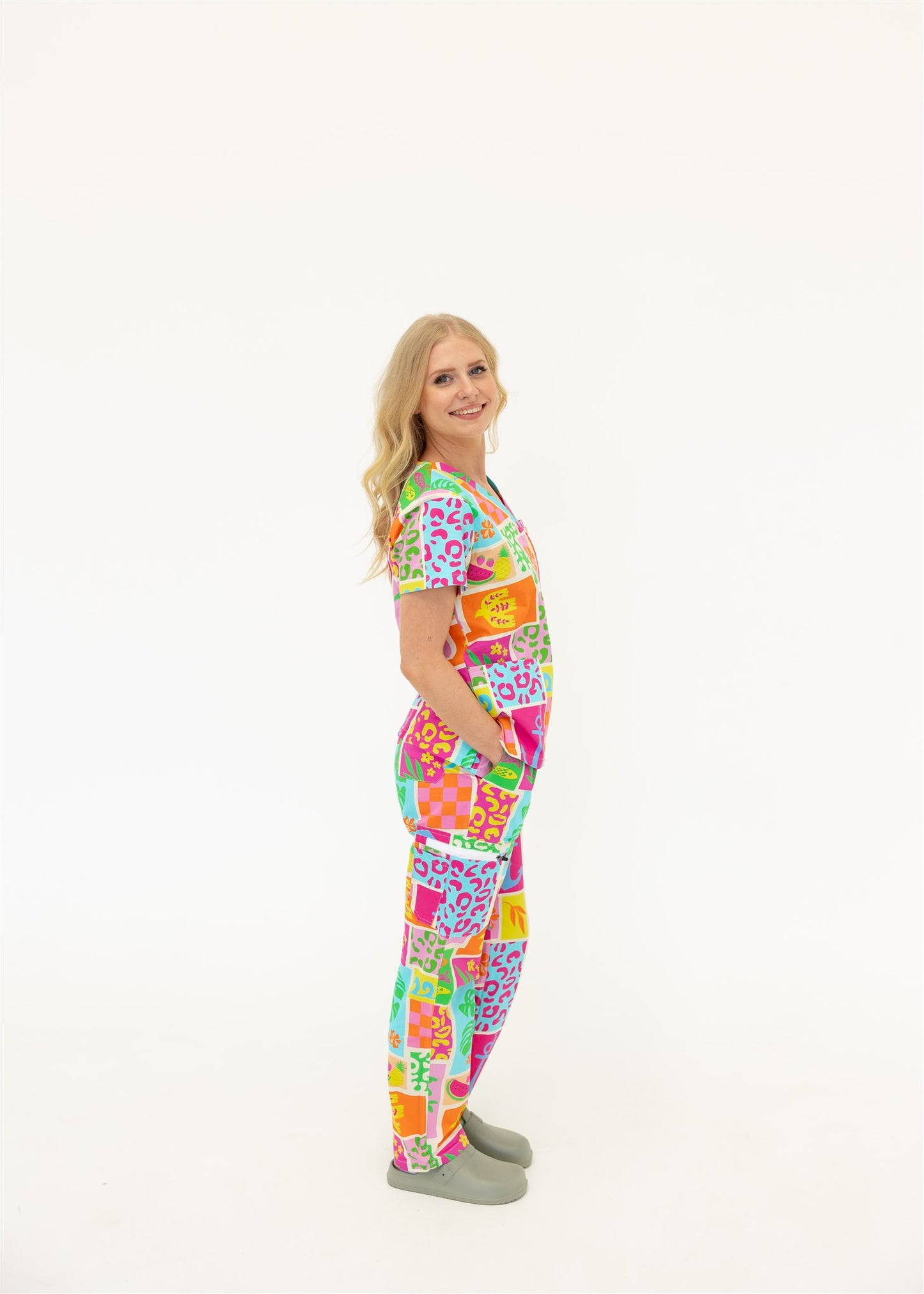 woman wearing a bright fun summery scrub set
