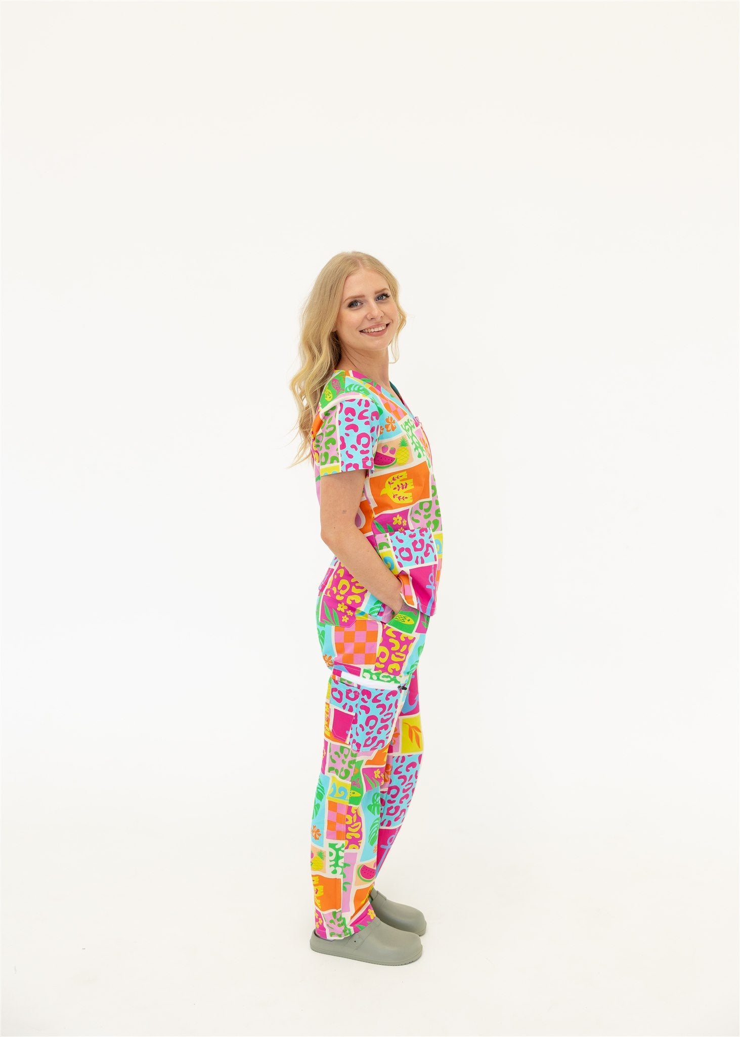 woman wearing a bright fun summery scrub set
