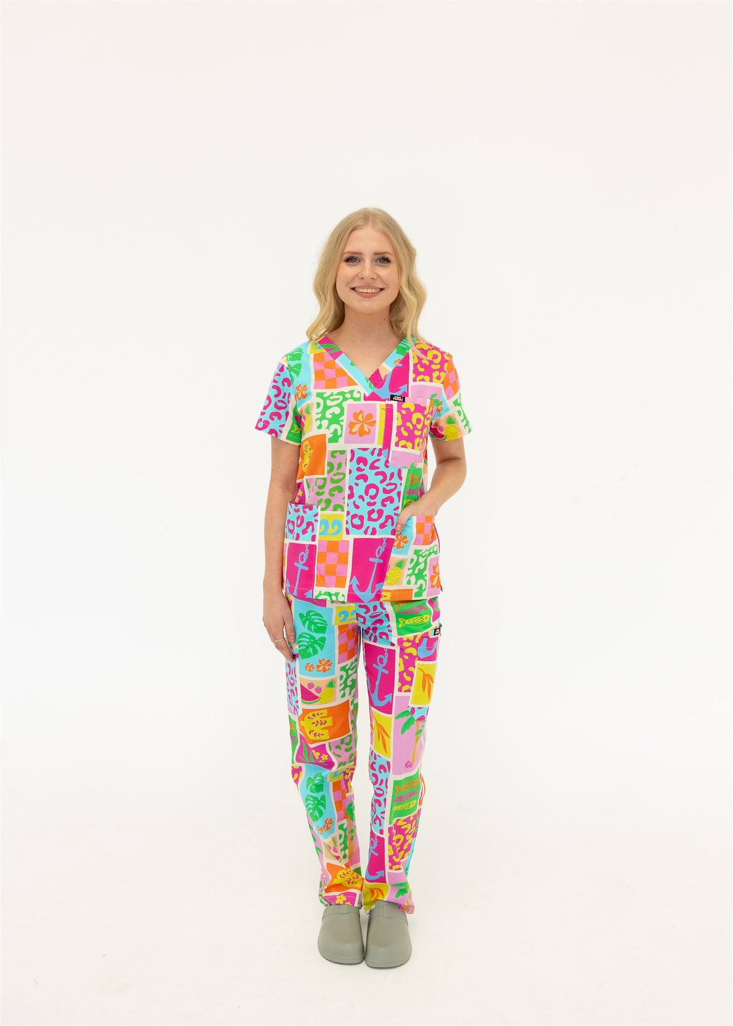 woman wearing a bright fun summery scrub set