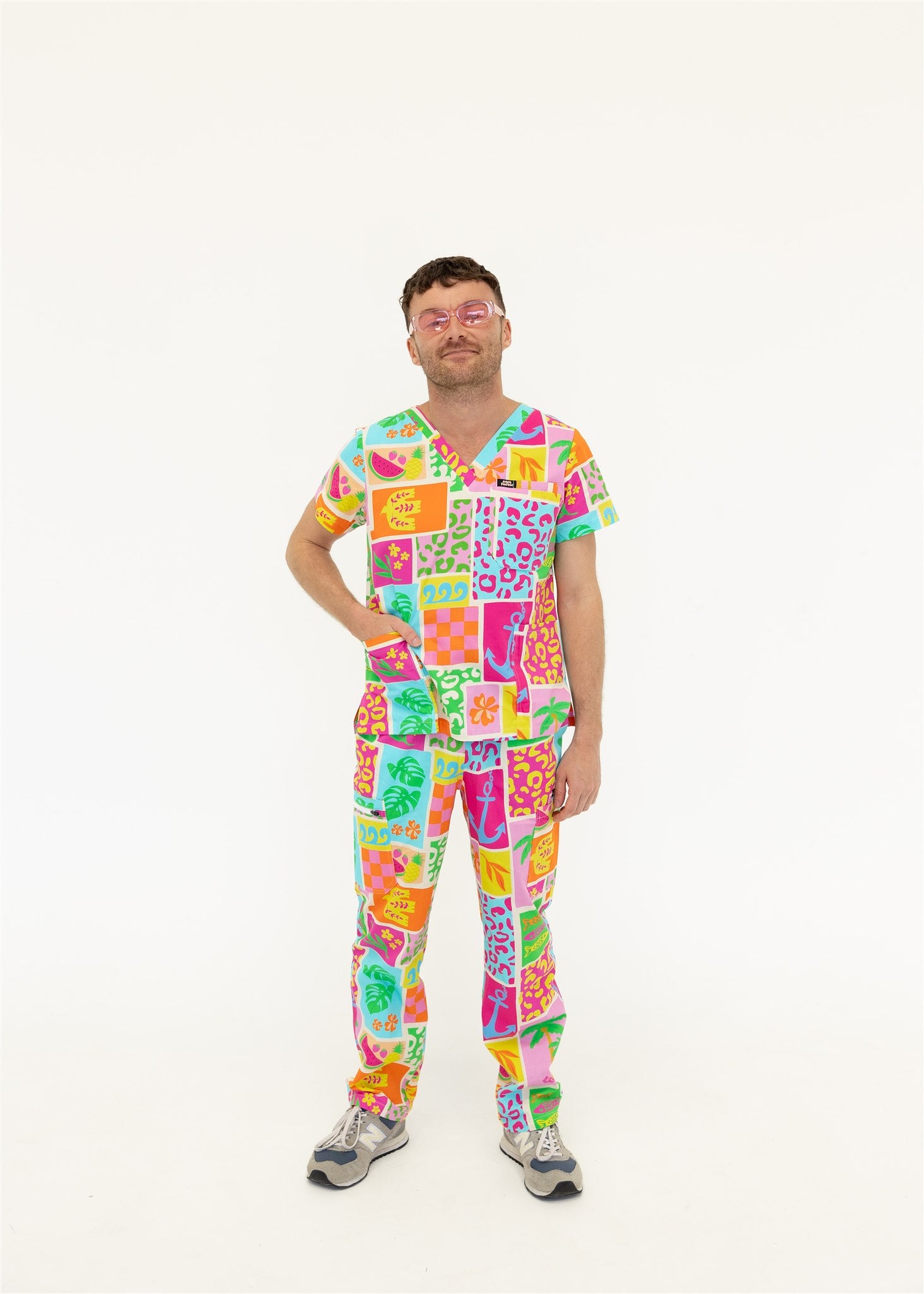 man wearing a bright fun summery scrub set
