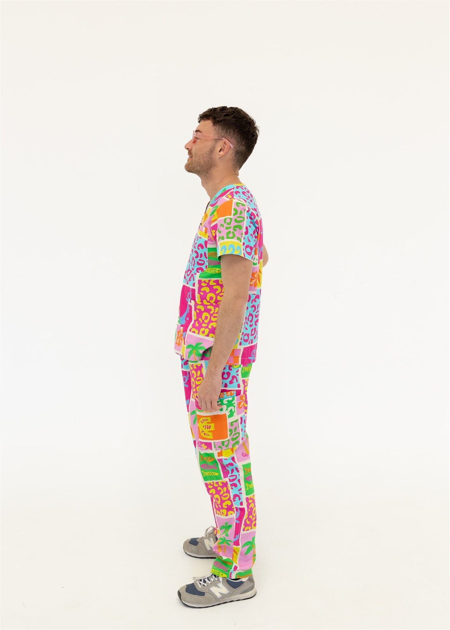 man wearing a bright fun summery scrub set
