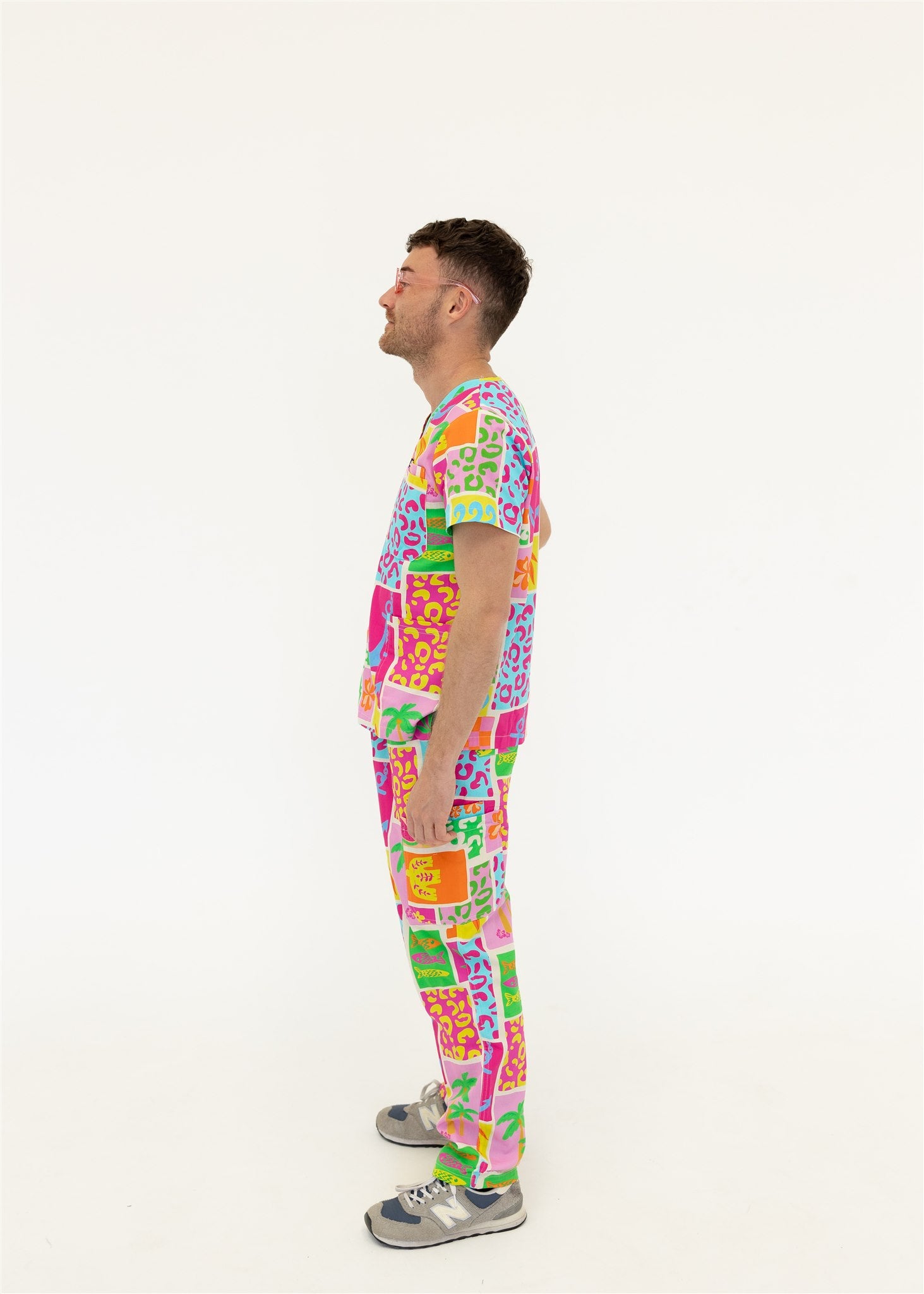 man wearing a bright fun summery scrub set