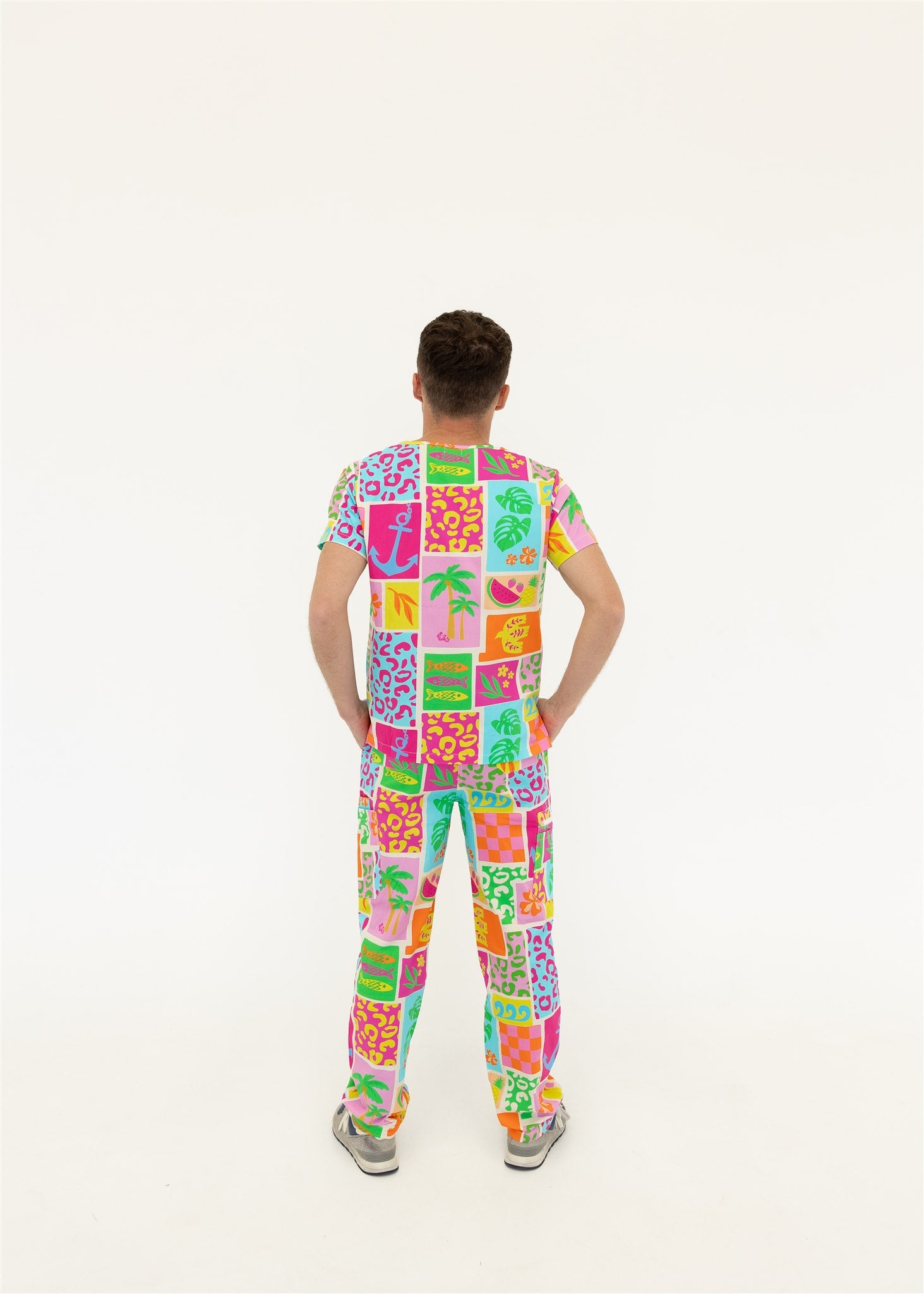 man wearing a bright fun summery scrub set