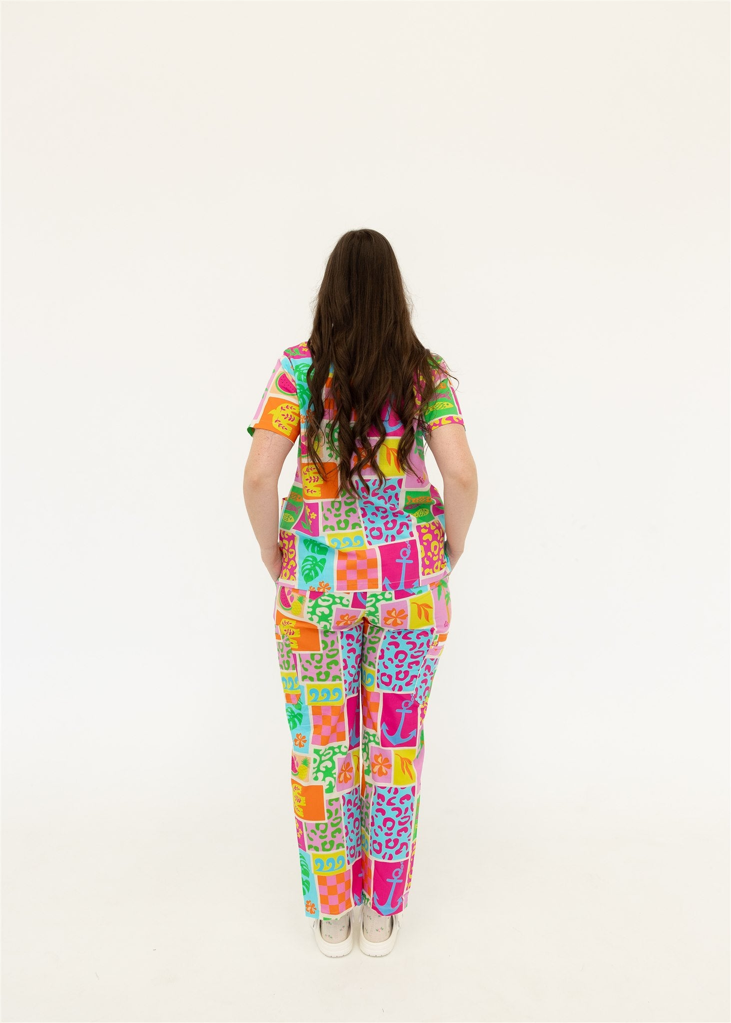 woman wearing a bright fun summery scrub set